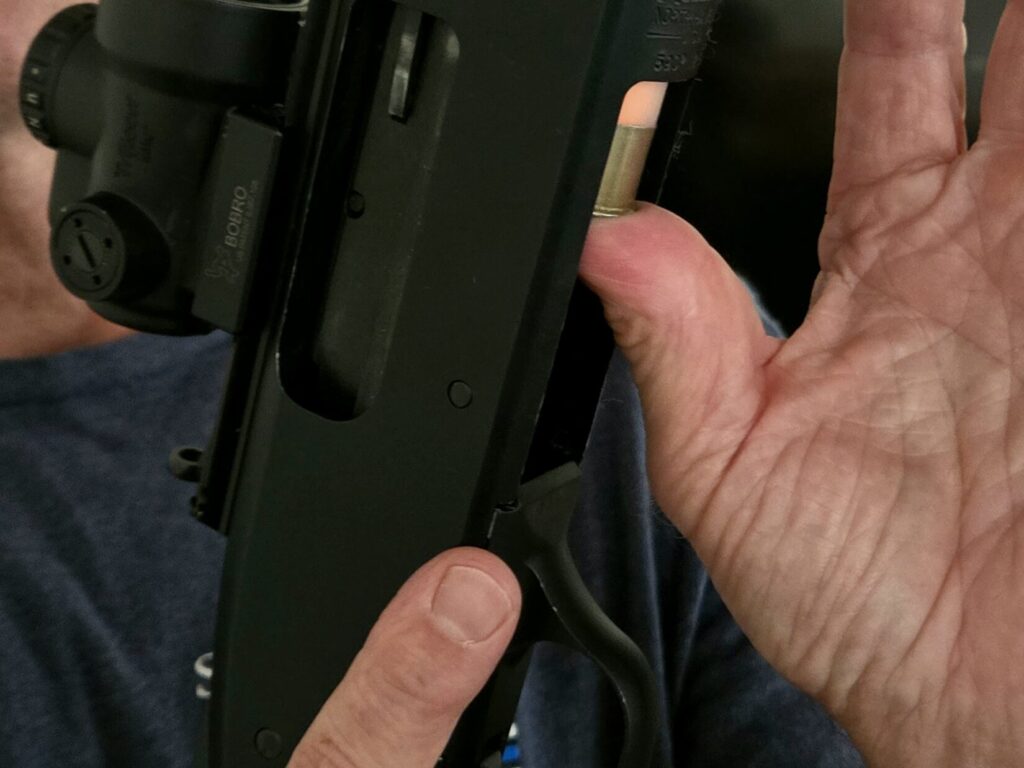 Shotgun being unloaded through the magazine tube without the need to chamber shells.