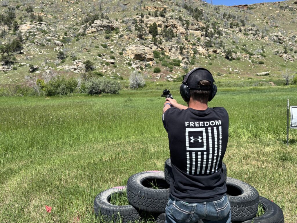 Bridger engaging a target free hand in revolver optics division at Handgun Hunters Competition