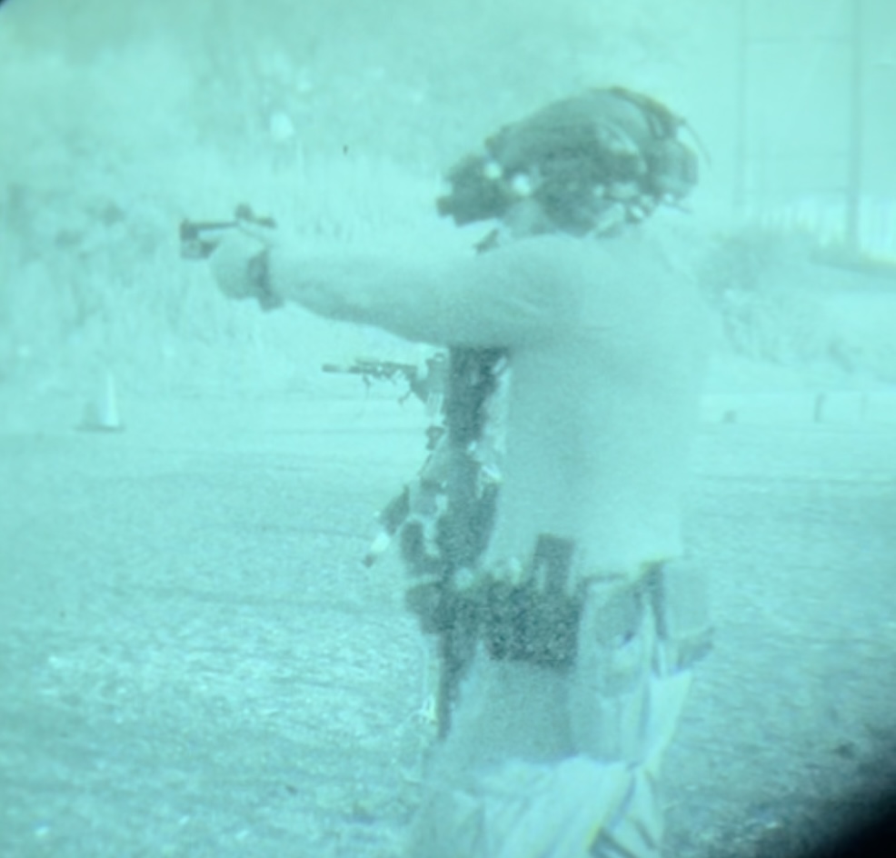 Pictured is a law enforcement officer conducting a carbine to pistol transition under night vision goggles
