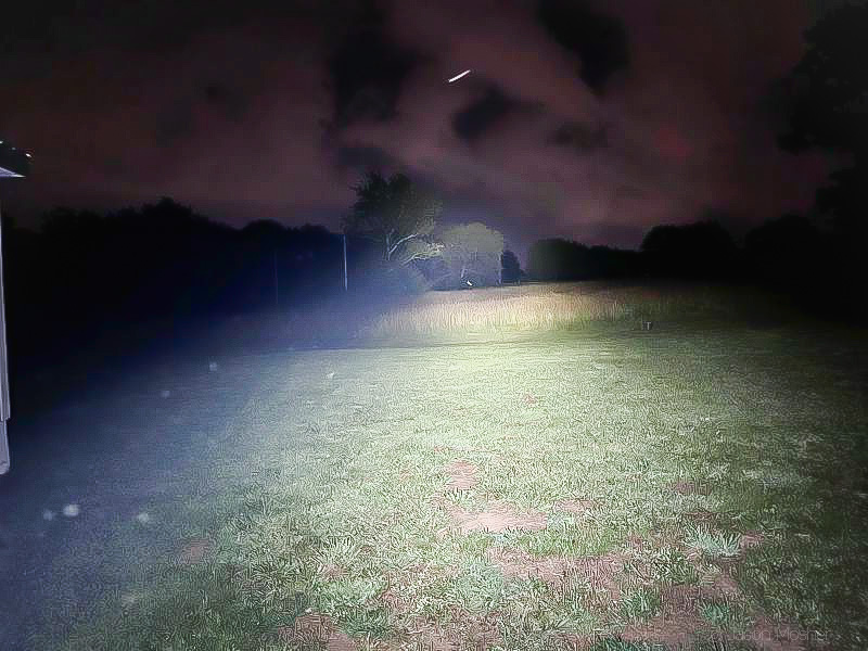 Need a big light? Try the ProTac HL6. Image showing beam destance in a yard at night.