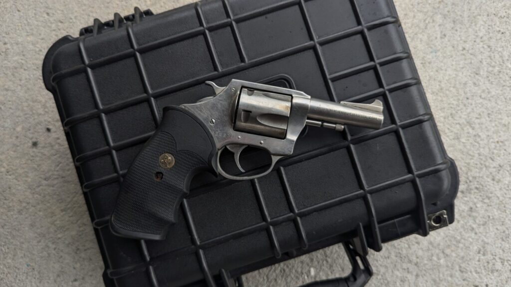Revolver on a black hard case.