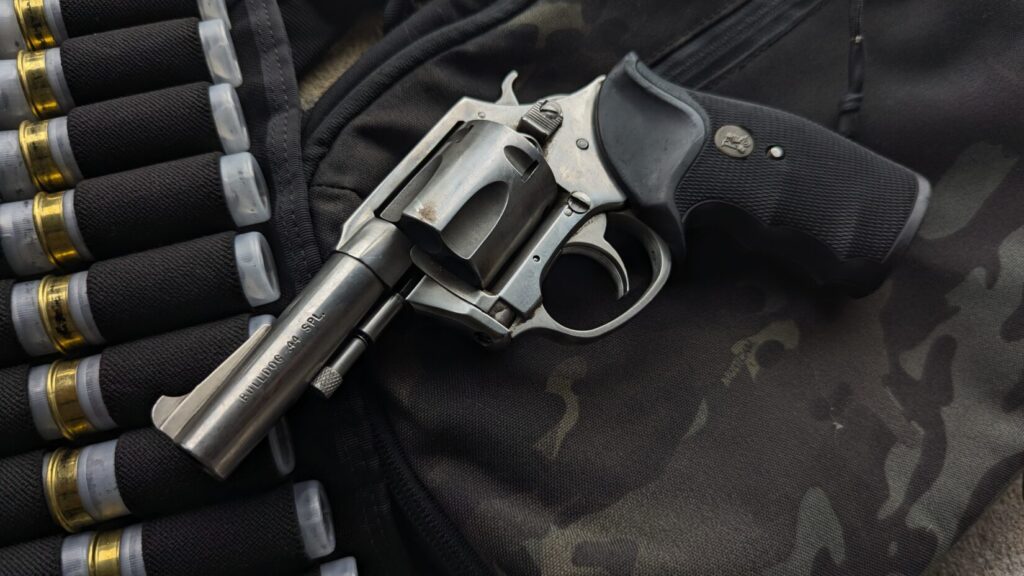 Revolver and shotgun shells on camouflage bag