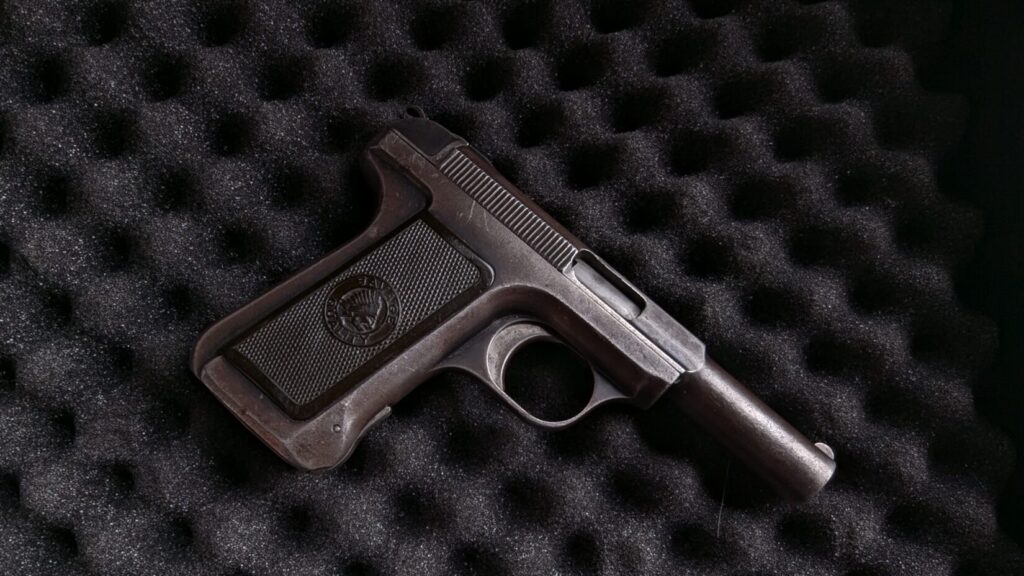 Historic Concealed Carry handguns, Savage model 1907 on black foam.