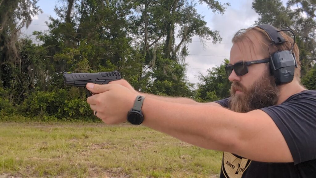 man shooting the KelTec P15 outdoors
