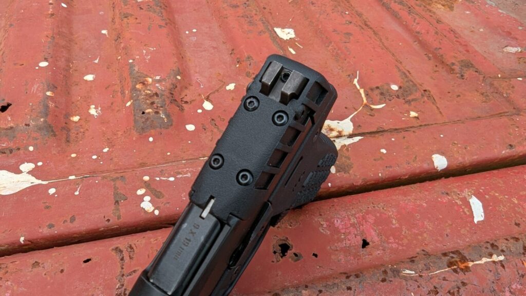 Top of KelTec P15, showing the removable plate on the slide where an optic could be mounted