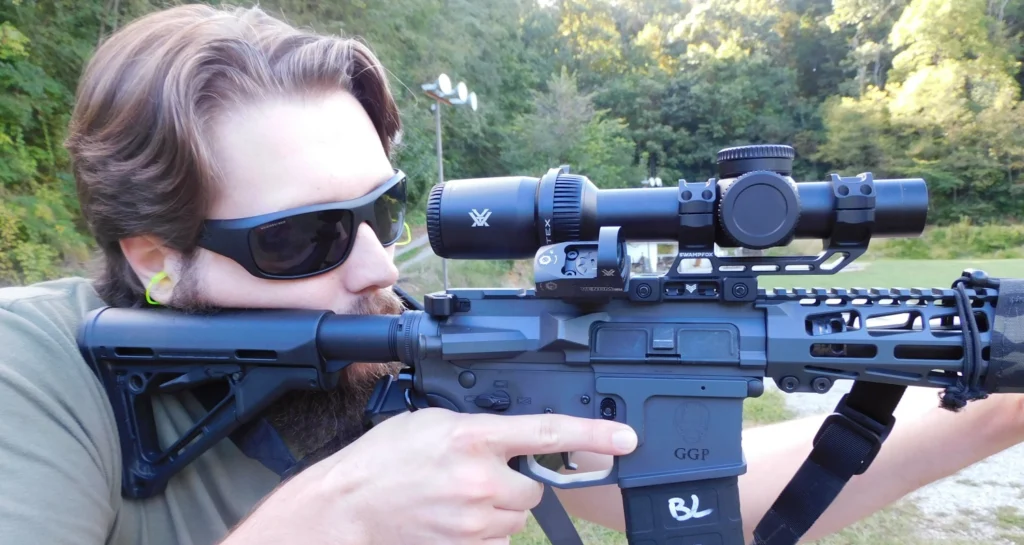 man firing an AR-15 rifle