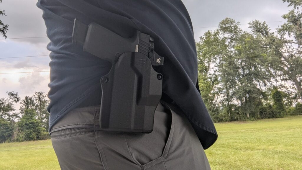 Person wearing a pistol in a Solis holster.