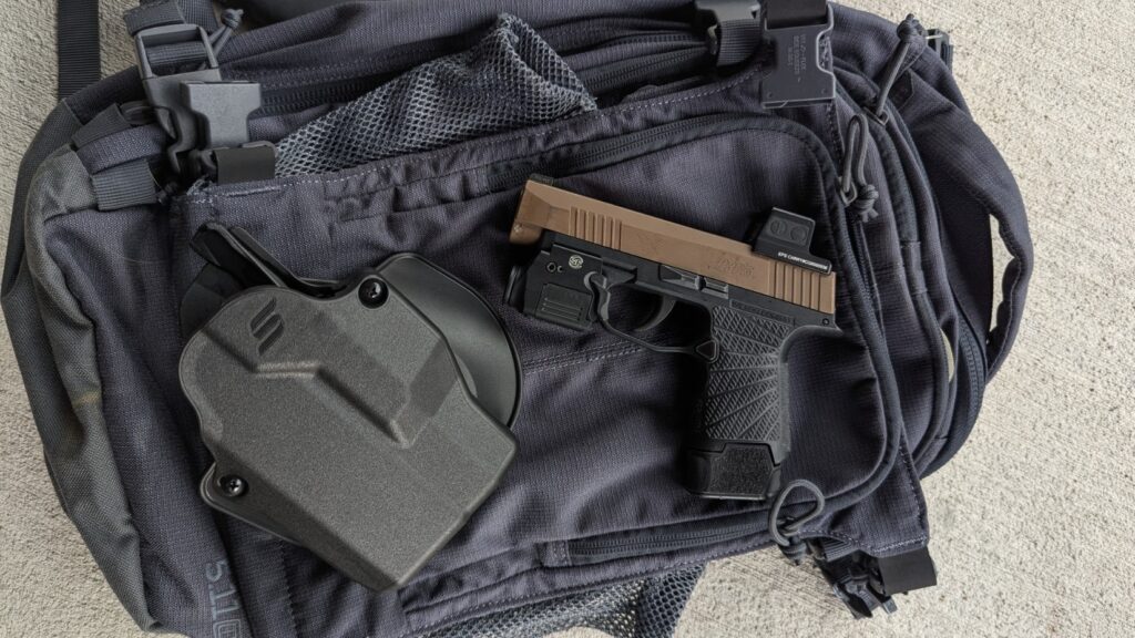 SIG Sauer P365 with holster on a bag