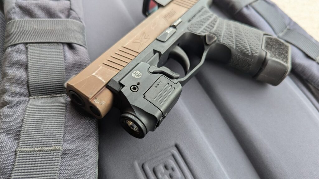 SIG Sauer P365 with SureFire XSC light and red dot sight.