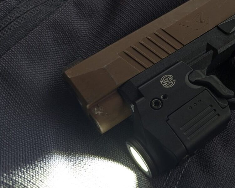 Close-up of a SureFire XSC weapon light on a SIG Sauer P365
