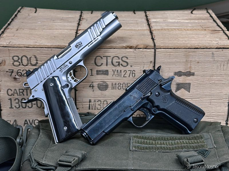 1911 handguns leaning against wooden ammo crate, one is a Bul Armory and the other is a Llama .45 ACP from Gabilondo y Cia