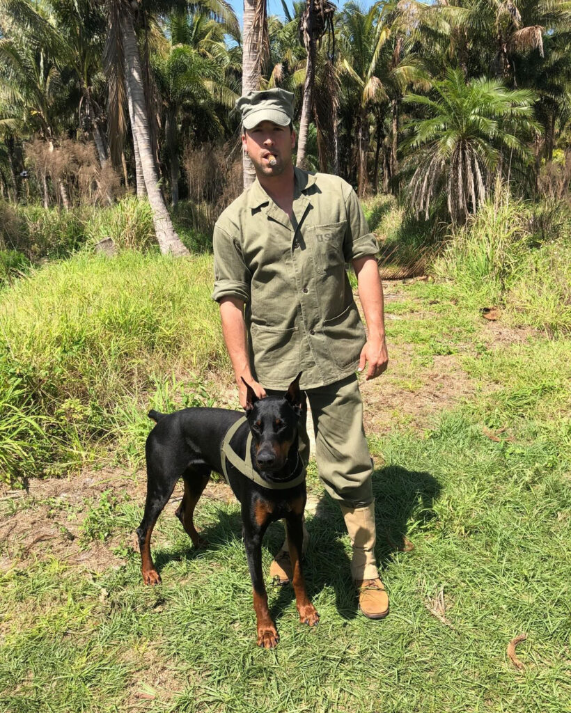 Pictured is K9 Duke a Doberman Pincher, next to a marine actor on the set of the short movie Walking Point