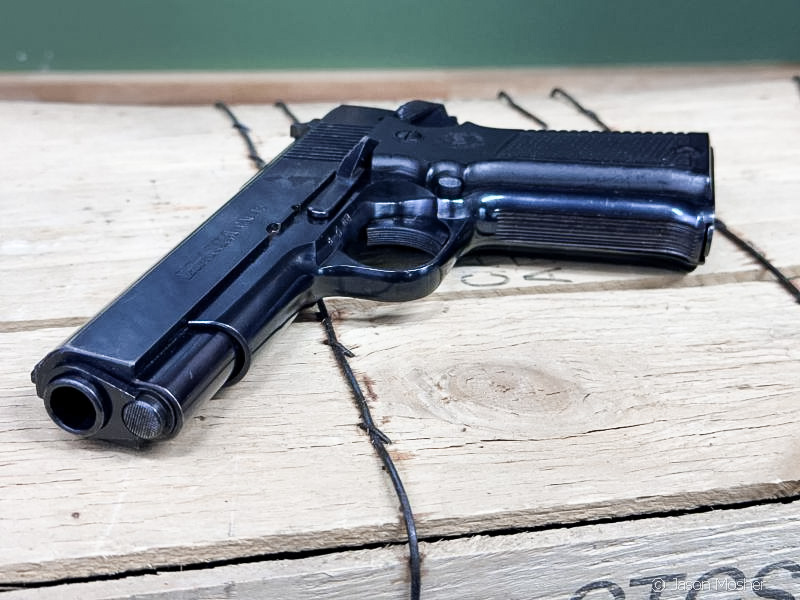 Llama .45 AUTO for 1911 lovers, lying on top of wooden ammo crate. 