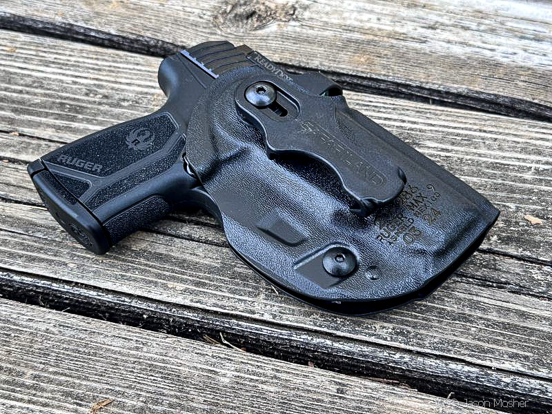 Ruger Max-9 with ReadyDot optic in Safariland Species holster on wooden surface
