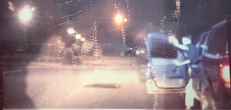 Grainy bodycam footage showing suspect shooting at Alex Broder