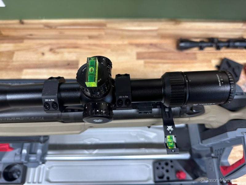 Align the scope with the rifles bore axis.