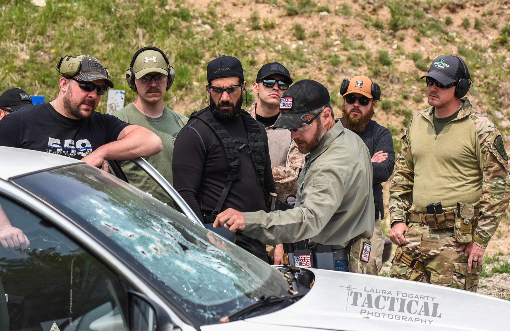 in this photo, Rick Hogg of War HOGG Tactical conducts a windshield inspection with law enforcement officers after a live fire demonstration