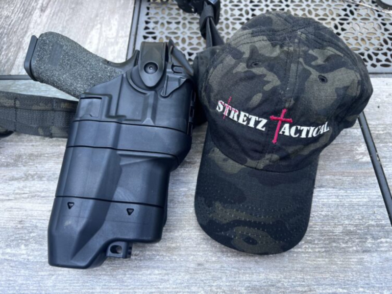 Safariland Ballast holster next to Stretz Tactical hat