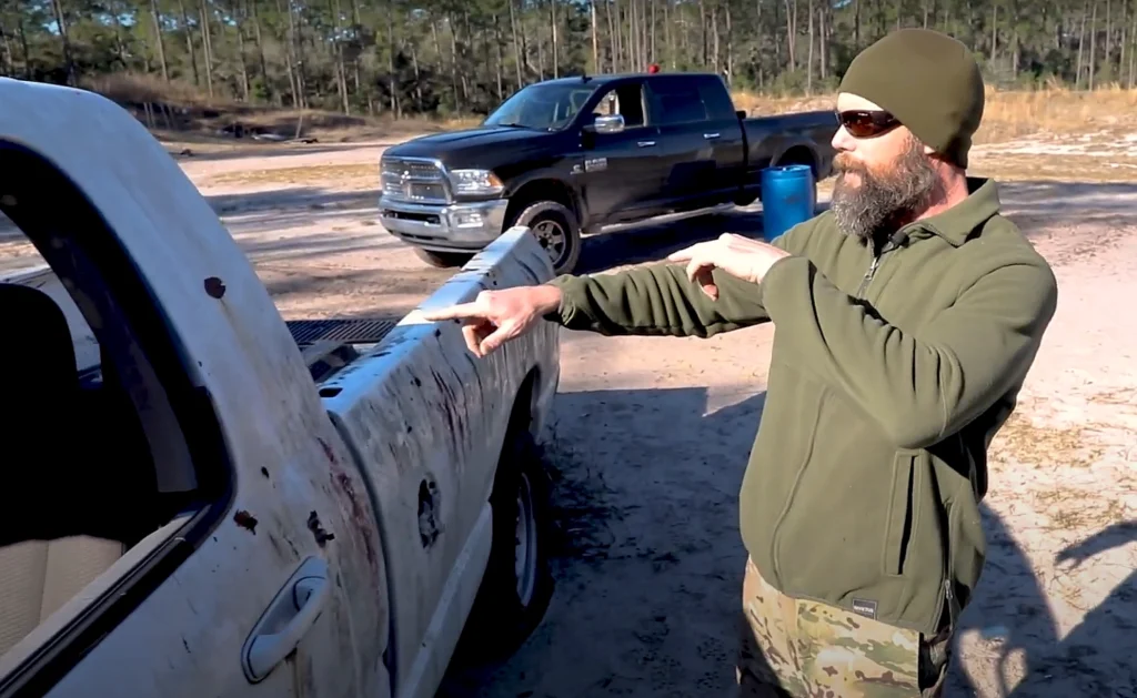 man demonstrating how an outside assailant has a mobility advantage in a car attack.
