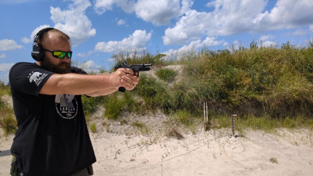 Man aiming Echelon pistol side profile.