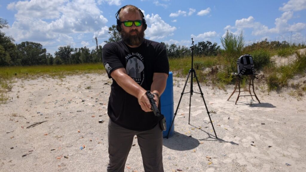 Man holding Echelon pistol, looking forward.