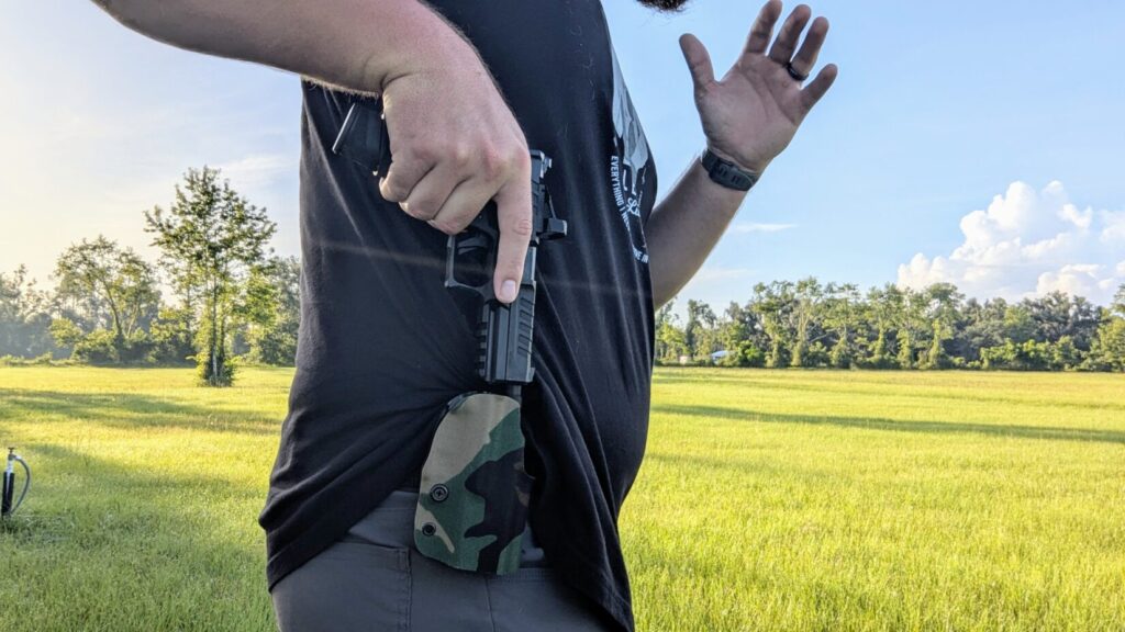 Man drawing pistol from IWB Gravity holster.