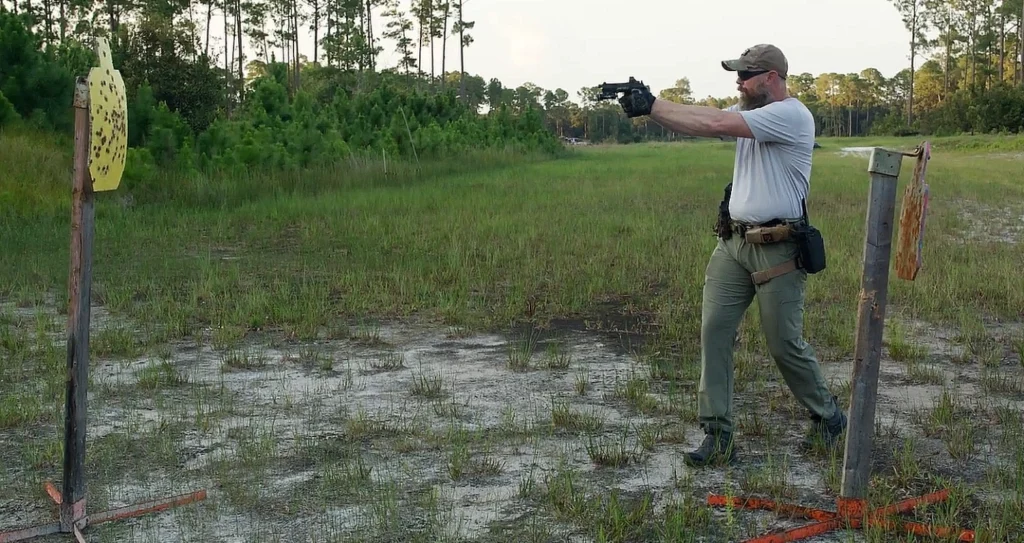 main aiming handgun, outdoor range. Steel target in foreground, before line to target