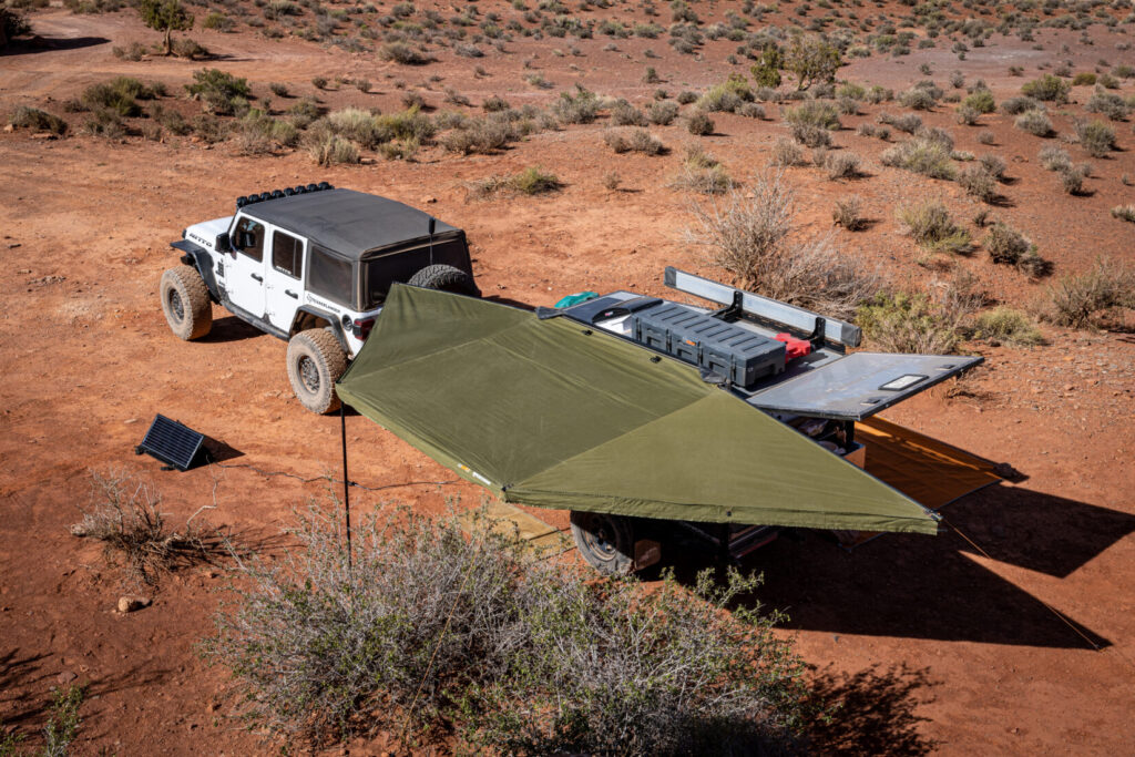 Overland trailer provides shade, kitchen, and sleeping arrangements in the backcountry.