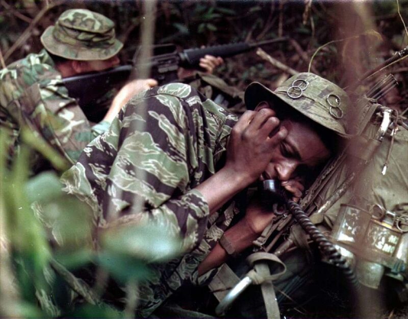 Vietnam soldier using phone in the battlefield, he's wearing tiger stripe camo