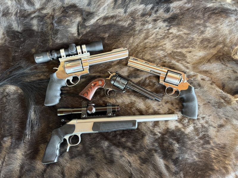 The CVA Scout Pistol (bottom) is a bargain for the handgun hunter. Ruger's Blackhawk models (center) can be purchased on the used market at affordable prices for the hunter on a budget.