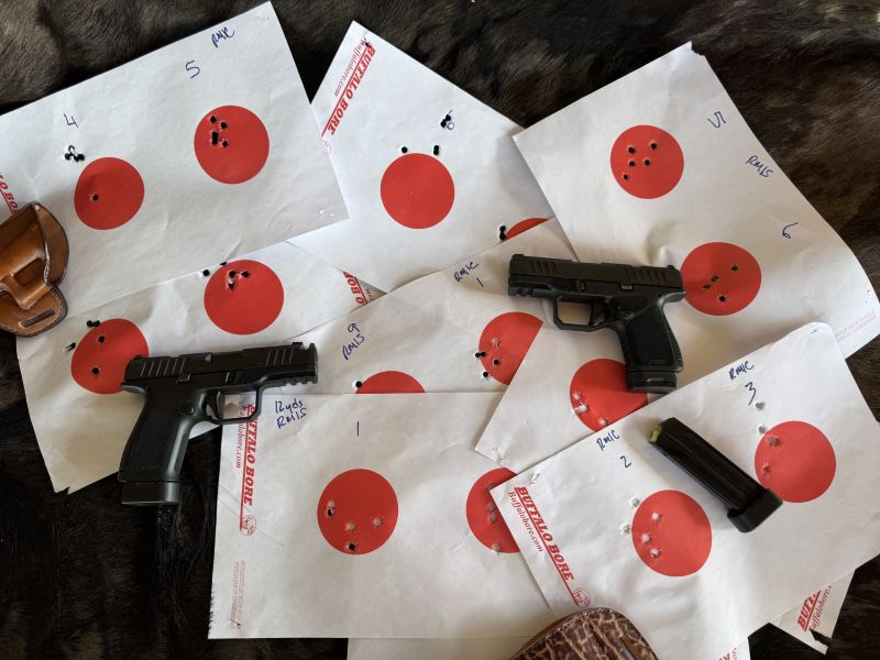 The Rost Martin RM1S Subcompact and RM1C Comp pistols on paper targets showing shot groups indicating an assortment of good ammunition from Buffalo Bore, Hornady, and Remington.