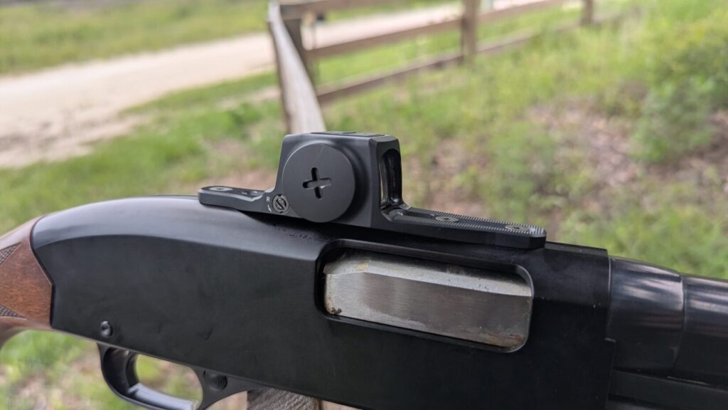Angled view of a Vortex Viper red dot sight on a shotgun, showing the ejection port.