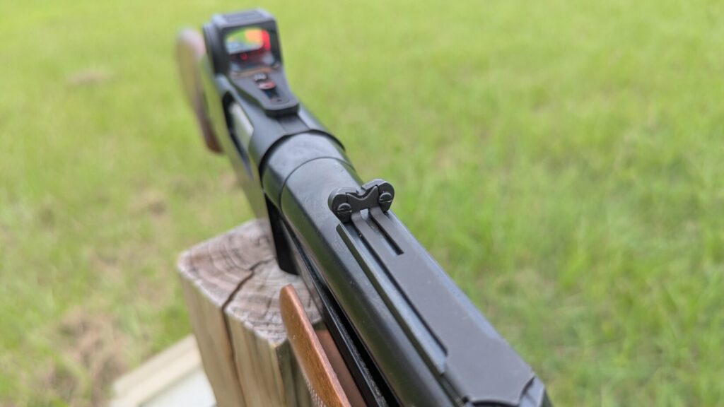 Angled side view of a Vortex Viper red dot sight on a shotgun.