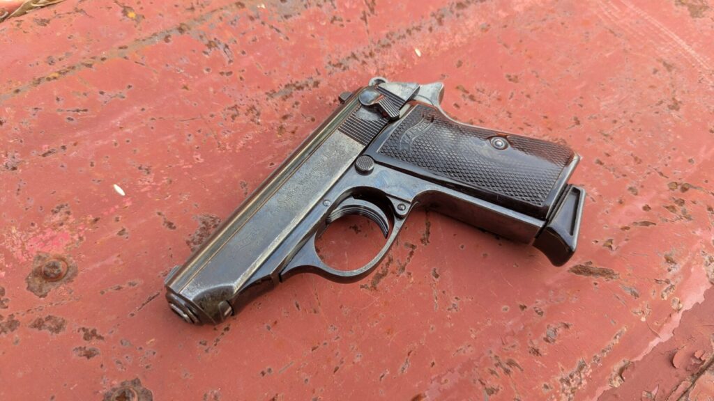 Walther PPK/s pistol on red textured surface