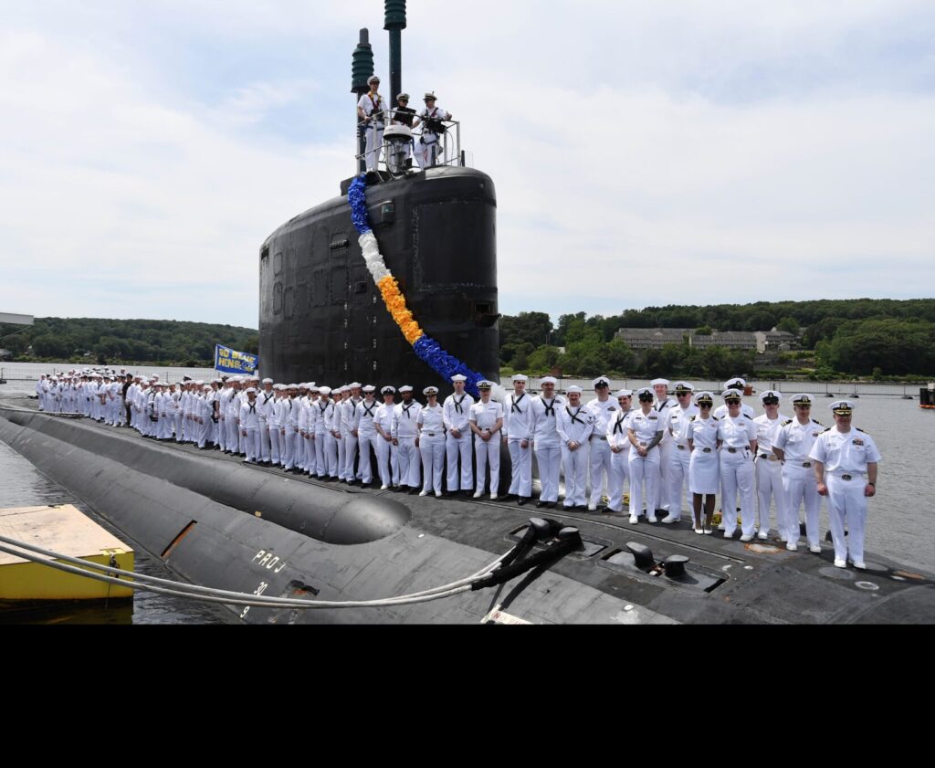 The crew of the Virginia-class fast-attack submarine USS Delaware (SSN 791) gathers top-side for a command photo