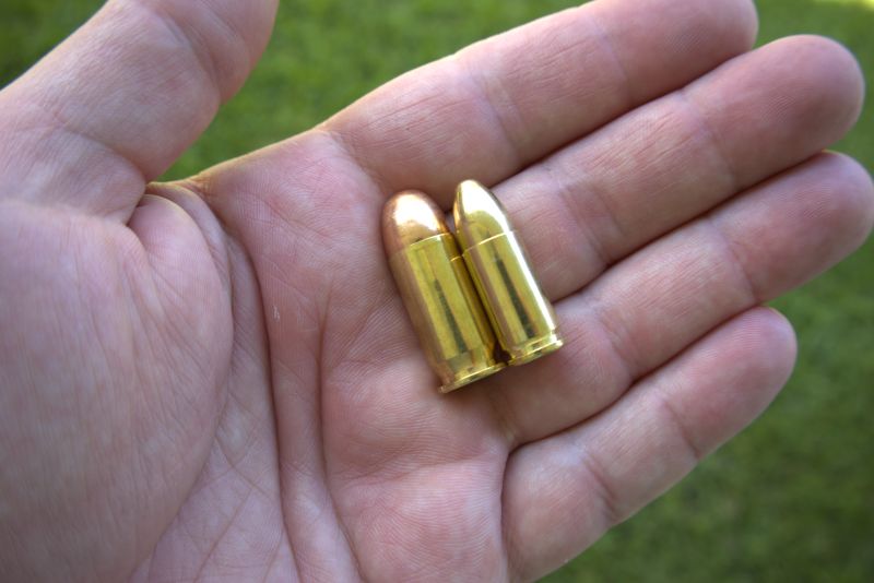 45 acp and 9mm luger cartridge side by side in hand