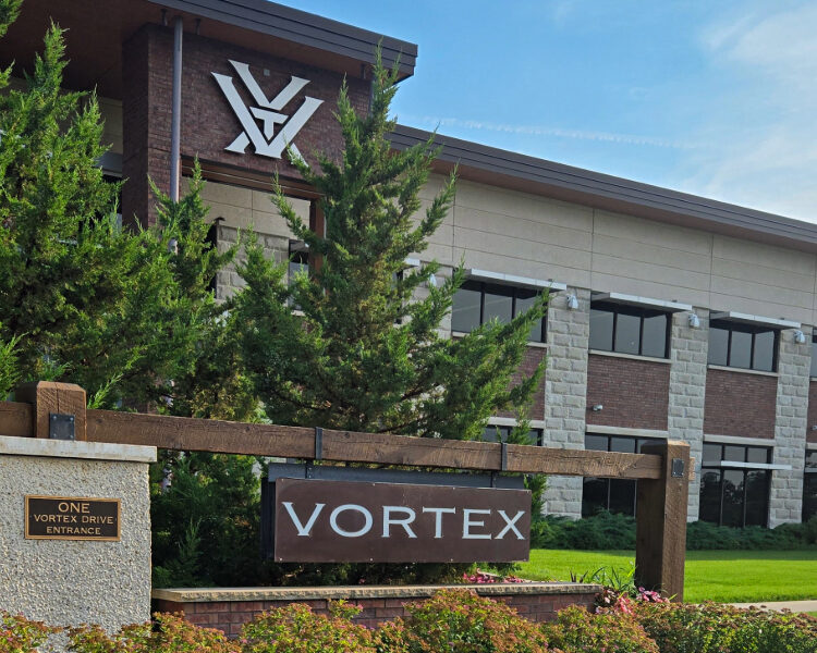 Image of the aVortex facility with wooden sign and colorful garden