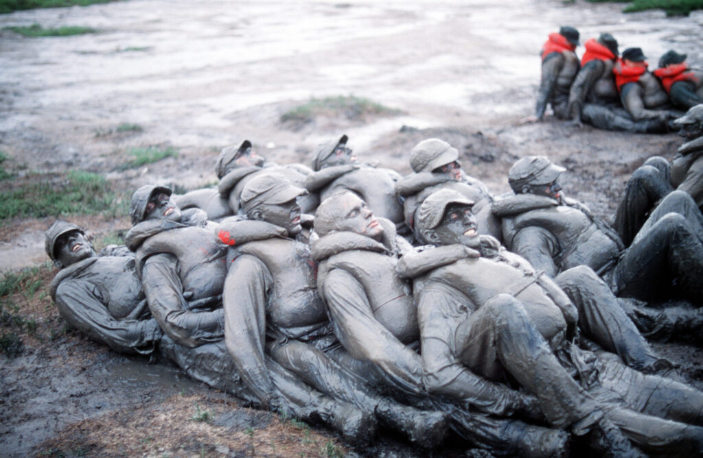 BUD/S trainees participate in a training exercise in the mud. (U.S. Navy photo. Public Domain)