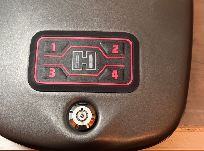 Thye lock and access area of a Hornady gun safe. The safe is grey with red buttons above the lock. 