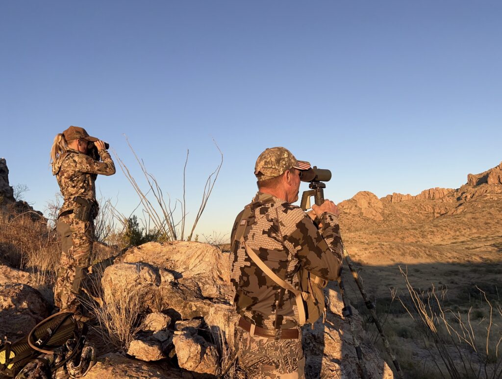 hunters looking through optics