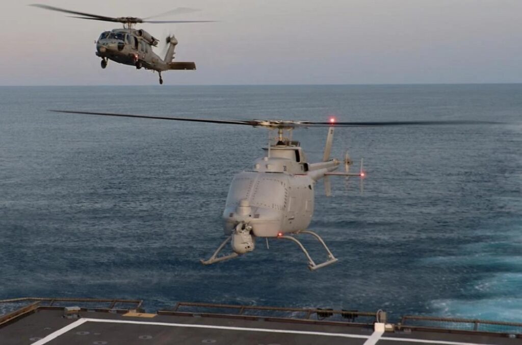 Human-machine teaming in naval operations. The MQ-8C Fire Scout (right) is used as a remotely piloted vehicle. Advances in artificial intelligence and machine learning could turn it into an autonomous partner relatively quickly. (U.S. Navy photo by Alexandra Green. Public Domain)