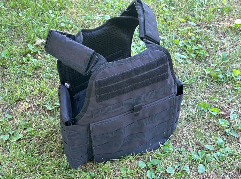 A black plate carrier sitting on the grass. 