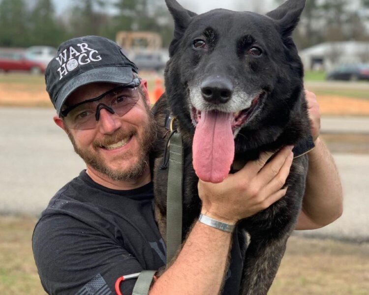 Pictured is Rick Hogg owner of War HOGG Tactical and SOF K9 handler with Combat Assault Dog Duco on his shoulder