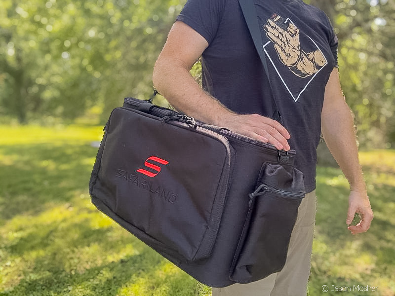 A man in a black shirt walking with the Patrol Bag slung over his shoulder.