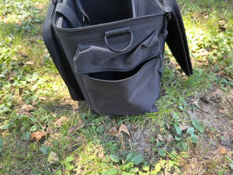 A view of the patrol bag from the side with the side pocket unzipped.