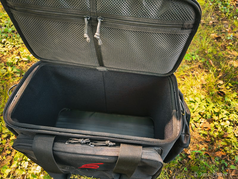The Patrol Bag sitting on the ground with the top open so you can see the open area inside.