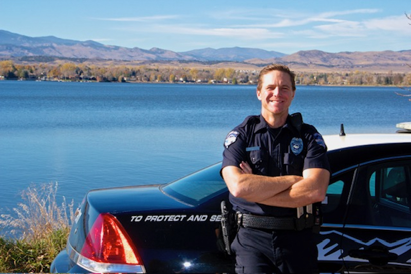 Officer Garret Osilka seen up against patrol vehicle