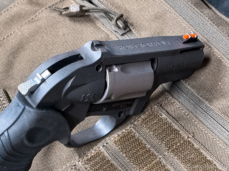 A view of the Taurus 605 Poly from above, with the revolver propped up on a green canvas. 