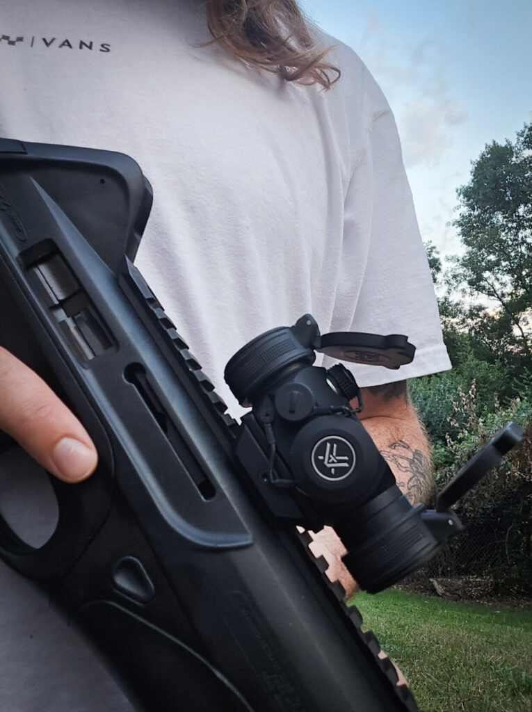 A man holding a Beretta CX4 Storm with a Vortex SPARC II red dot.
