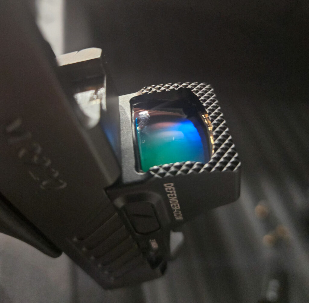 Vortex red dot lens against a dark background.